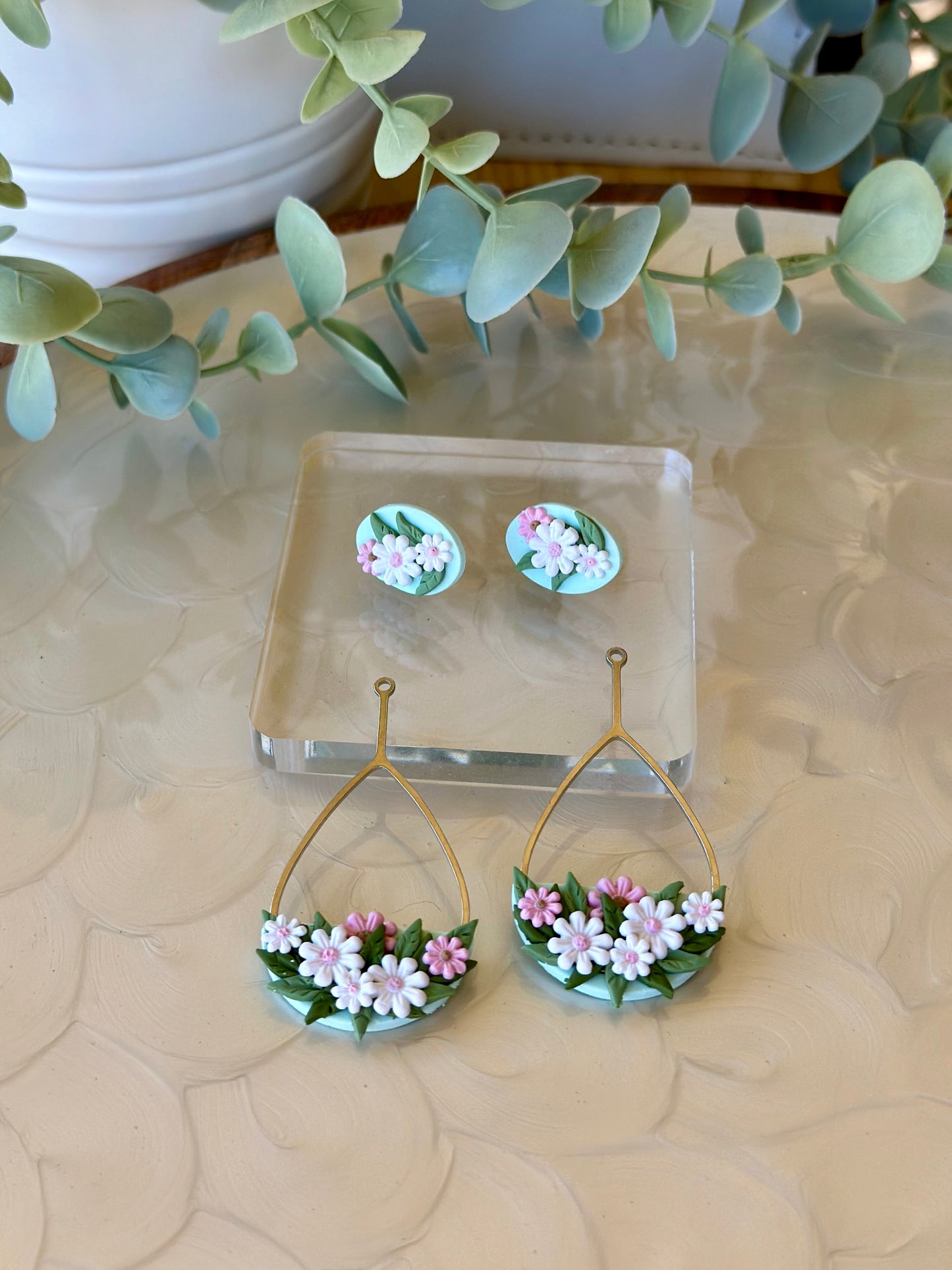 Handmade floral earrings with pink and white polymer clay daisies and green leaves on teardrop frame – Duelling Daisies Pink Daisy by Mandi P Designs