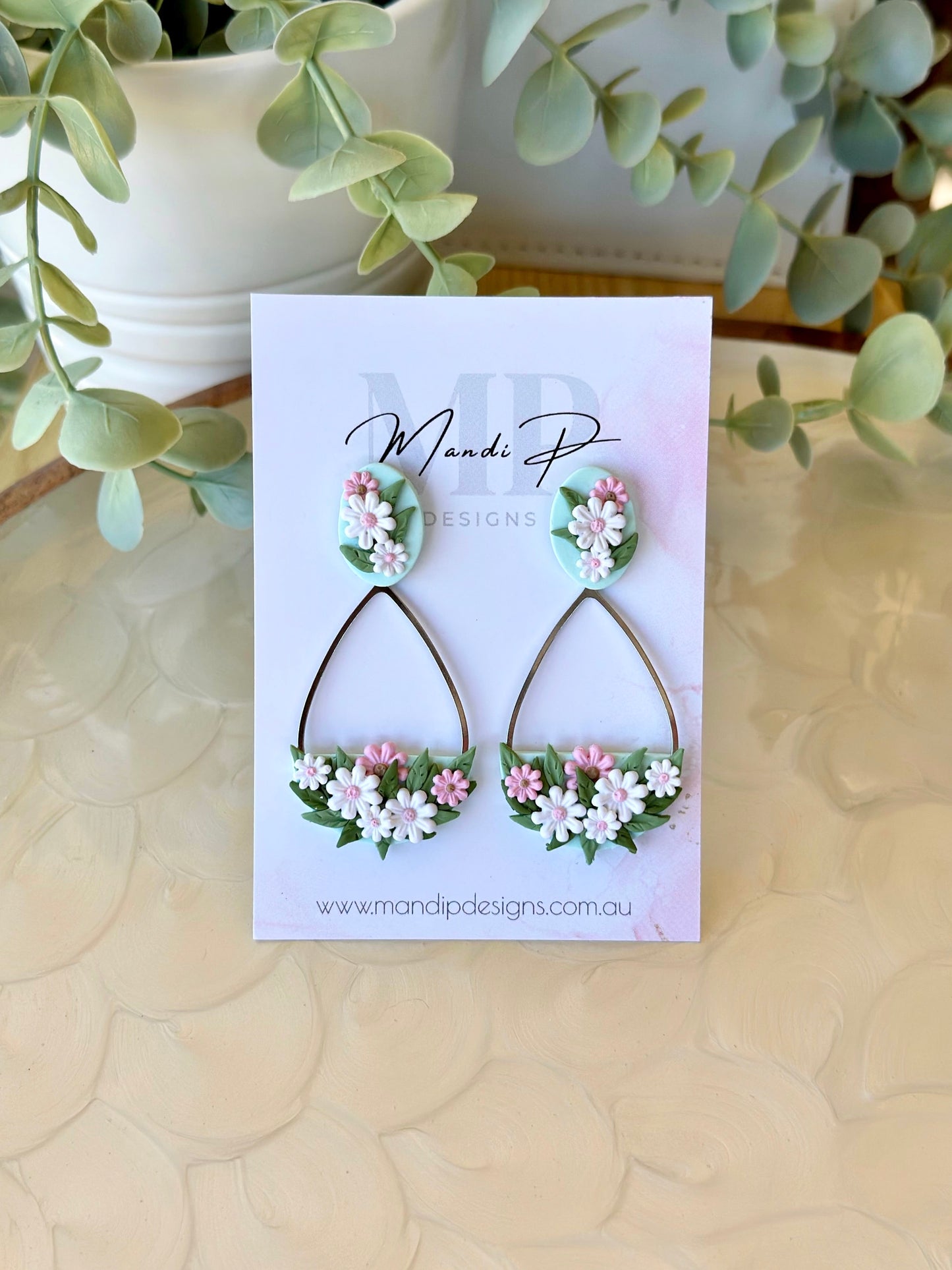 Handmade floral earrings with pink and white polymer clay daisies and green leaves on teardrop frame – Duelling Daisies Pink Daisy by Mandi P Designs