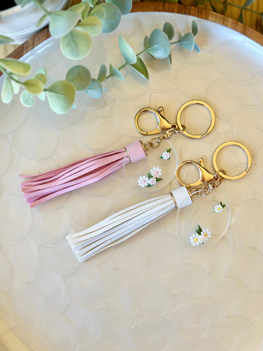 Handmade yellow and white daisy keyrings with white and pink vegan leather tassels on gold hardware – polymer clay floral charms on acrylic discs