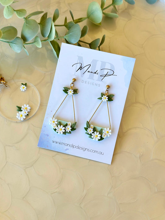 Handmade mint green and yellow daisy dangle earrings with gold-plated teardrop frame and floral polymer clay detailing – Kelly earrings by Mandi P Designs